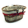 Basket lined with cream linen, decorated with red ribbon and wooden hearts