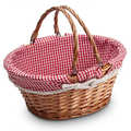 Natural wicker basket with two handles lined with red and white fabric from Vichy