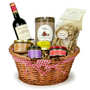 Natural wicker basket with two handles lined with red and white fabric from Vichy