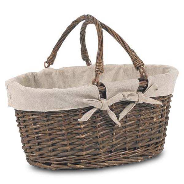 Large brown wicker basket with two handles lined with linen